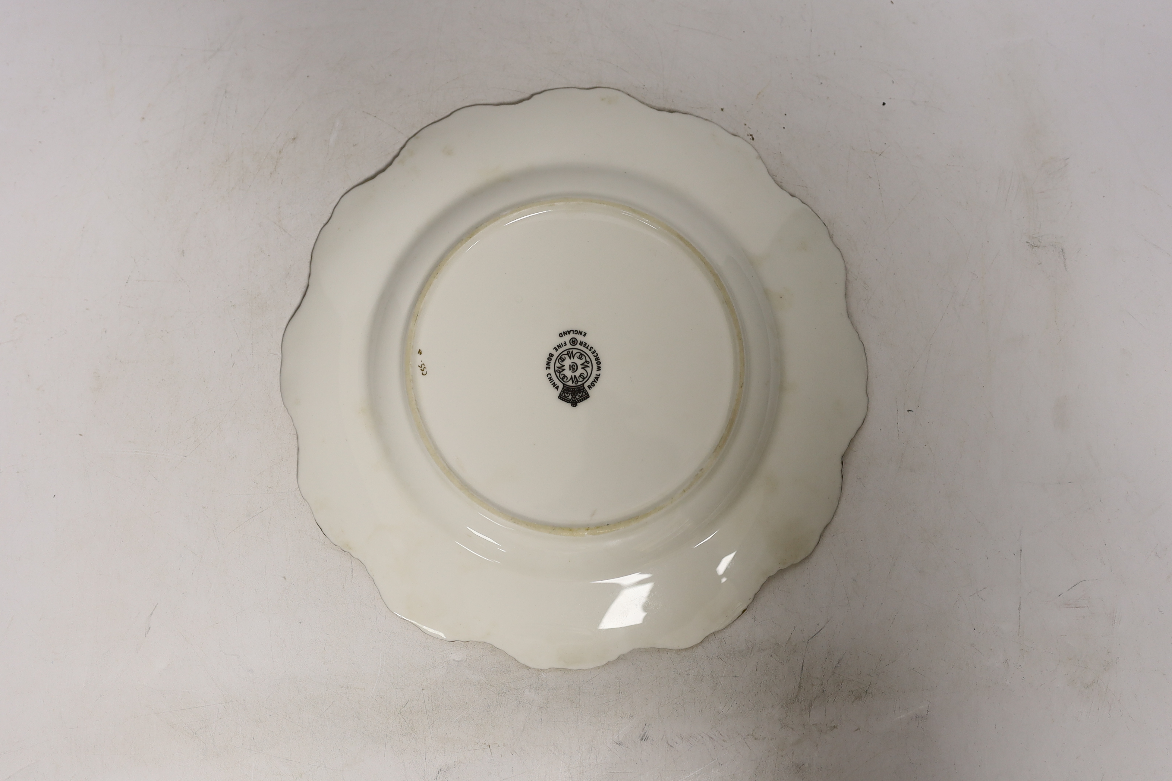 A pair of Royal Worcester fruit painted plates, post war, signed Freeman, 22.5cm